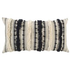 a black and white striped pillow with fringes on the edges, in front of a white background