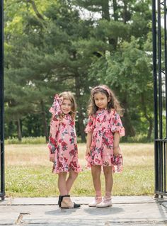 Brighten up your kid's wardrobe with our playful Flora Flower Print Dress! This dress features a vibrant floral pattern that is sure to make them stand out. Its lightweight fabric and loose fit provide comfort for all-day wear. Perfect for any occasion, this dress is a must-have for your stylish little one! Pink Dress with Pink, Red, Yellow Floral Accents This Style Fits True to Size and is Above the Knee Ruffle Trimmed Cape Sleeves Pearl and Jewel Hand Beading on Neckline Neck Tie High- Low Skirt Back Zipper Closure Made in Turkey Fully lined 95% Polyester, 5% Lycra Care Instructions Do Not Bleach, Do Not Iron, Do Not Tumble Dry Flower Print Jumpsuit, Pink Flower Print, Petite Jumpsuit, Print Jumpsuit, Kids Wardrobe, High Low Skirt, Beaded Neckline, Flower Print Dress, Cape Sleeves