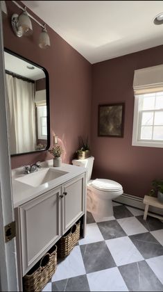 a bathroom with a checkered floor and walls