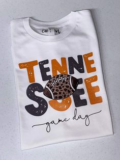 Welcome to Cotton and Pearls!  Tennessee and cheetah print <3 This unisex fit Bella canvas tee comes with the Tennessee design as shown above in the shirt color of your choice. All designs are hand pressed with professional grade heat transfer vinyl.  Please leave shirt color in the personalization box above.  Available in xs-3x Cotton Sports Fan Shirt For Game Day, Team Spirit Shirt With Screen Print For Game Day, Custom Print Tops For Football Season Game Day, School Spirit Tops With Custom Print For Game Day, Sports Fan Shirt With Graphic Print For Game Day, Screen Print Shirt For Game Day Fan Apparel, Game Day Fan Apparel Shirt With Screen Print, School Spirit Shirt With Screen Print For Game Day, Casual Game Day Shirt With Sublimation Print