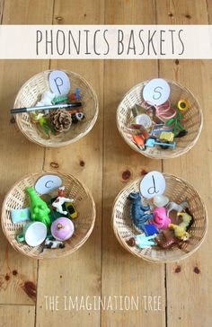 three baskets filled with toys and numbers on top of a wooden floor next to the words phonicics baskets