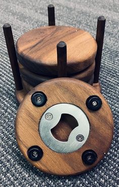 two wooden objects with black knobs sitting on the ground