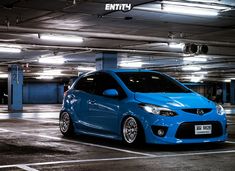 a blue car parked in a parking garage