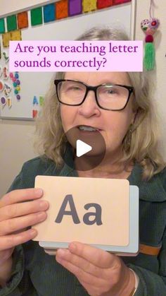 a woman holding up a sign with the words are you teaching letter sounds correctly?