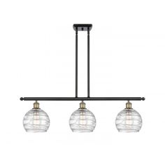 three light chandelier with glass globes hanging from an adjustable ceiling fixture in black and gold