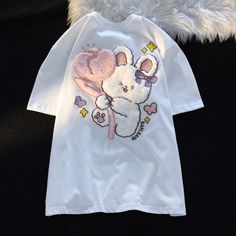 Elevate your kawaii fashion game with our Fluffy Tulip Bunny T-Shirt! This kawaii t-shirt showcases a fluffy bunny nestled amidst vibrant tulips, creating a delightful and charming design. Crafted for comfort, this kawaii T-shirt is perfect for showcasing your love for all things cute and cozy. Available in a range of sizes, this Fluffy Tulip Bunny T-Shirt is the ideal addition to your kawaii wardrobe. Kawaii Y2k Aesthetic, Christmas Elf Outfit, Unique Rabbit, Aesthetic Party, Kawaii Y2k, Christmas Tree Dress, Baggy Tops, Cartoon Tops, Bunny T Shirt