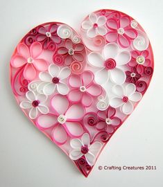 a paper heart made with buttons on a white background for valentine's day or mother's day