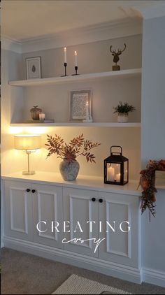 a white shelf filled with candles and vases on top of it's shelves