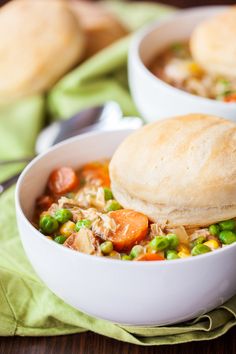 two white bowls filled with soup on top of a green napkin