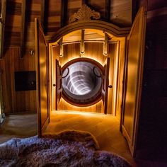 a room with a circular mirror in the middle and fur on the floor next to it