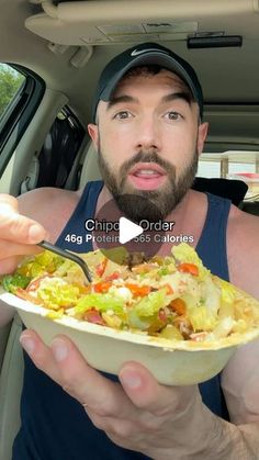 a man holding a bowl of food in his car