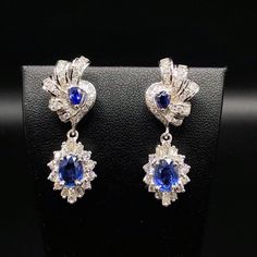 ENJOY OUR WORRY-FREE SERVICE AND THE DAZZLING, GENUINE JEWELRY WE DESIGN AND HANDCRAFT WITH LOVE❤️ ABOUT THE ITEM: STUNNING CEYLON BLUE SAPPHIRES AND NATURAL DIAMONDS, SET IN SIMPLE YET BEAUTIFUL 18K SOLID WHITE GOLD CHANDELIER EARRINGS WITH SCREWED BACK. Handcrafted, one of a kind earrings! Sparkling blue sapphire, and top grade, white and clean diamonds. These earrings will make you feel like a princess! SUGGESTED RETAIL VALUE: $9,800  BLUE SAPPHIRES: Weight: bottom 2 pieces, 2.58 carats, top Luxury Handmade Blue Chandelier Earrings, Traditional Luxury Blue Chandelier Earrings, Elegant Blue Nickel-free Chandelier Earrings, Classic Blue Diamond-cut Earrings, Classic Sapphire-colored Cubic Zirconia Diamond Earrings, Chandelier Wedding, Ceylon Blue Sapphire, Gold Chandelier Earrings, Wedding Chandelier