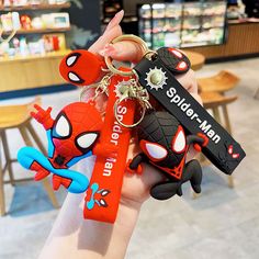 the spider man keychain is being held by someone