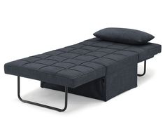 a bed with a pillow on top of it and a metal frame in the middle