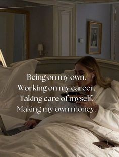 a woman laying in bed with a laptop on her lap and the words being on my own working on my career taking care of yourself making my own money