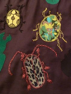 an image of some bugs and geckos on a cloth