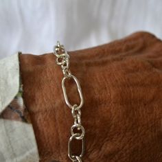 This sterling silver chain bracelet was entirely made by hand, except for the manufactured sterling silver foldover clasp. The bracelet has 3 distinct sizes of links, 2 different sizes of elongated links and the smaller round link, in a set pattern. You can easily attach a charm or charms to it. It has been polished to a bright finish. The one shown is a size 7 and ready to ship. If you want it adjusted up or down, just contact me and I can make the adjustment. There may be a slight price increa Everyday Sterling Silver Bracelet With Oval Link, Silver Oval Link Chain Bracelet Minimalist Style, Minimalist Silver Oval Link Chain Bracelet, Sterling Silver Paperclip Link Bracelet, Sterling Silver Paperclip Bracelet With Oval Links, Silver Chain Bracelet With Rectangular Links, Silver Oval Link Chain Bracelet, Sterling Silver Paperclip Bracelet With Solid Link Construction, Sterling Silver Paperclip Bracelet With Solid Link