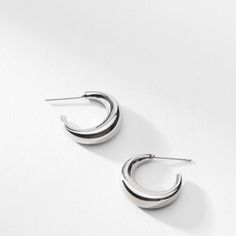 These crescent-moon-inspired earrings are just shiny enough to catch the light, but subtle enough to wear every day. Made from stainless steel. Elegant Crescent Hoop Earrings For Everyday, Modern Crescent Hoop Earrings For Everyday, Modern Semi-circle Earrings For Everyday Wear, Modern Semi-circle Earrings For Everyday, Minimalist Metal Earrings With Shiny Finish, Modern Crescent Jewelry For Pierced Ears, Minimalist Crescent Hoop Earrings For Everyday, Silver Sleek Everyday Earrings, Elegant Semi-circle Metal Earrings