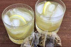 two glasses filled with ice and lemon slices