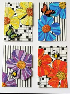 four different colored flowers are on the checkered paper