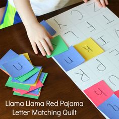 a child playing with letter matching paper