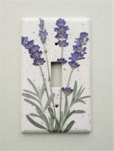 a light switch cover with flowers painted on it