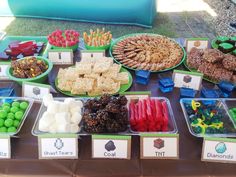 a table topped with lots of different types of snacks and desserts next to each other