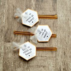 three wooden chopsticks sitting on top of a table with some writing on them