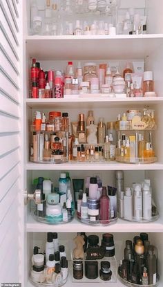 an open refrigerator filled with lots of different types of bottles and containers on it's shelves