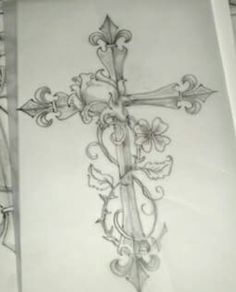 a drawing of a cross with flowers on it