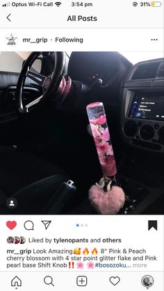 a pink snowboard sticking out of the center console of a car's dashboard