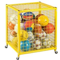 a yellow cage filled with lots of different colored balls and helmets on top of each other