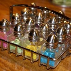 a metal container filled with lots of different colored confections