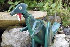 a toy dinosaur sitting on top of a pile of rocks