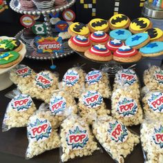 a table topped with lots of cakes and cupcakes