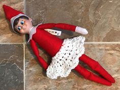 an elf laying on the floor with his legs spread out