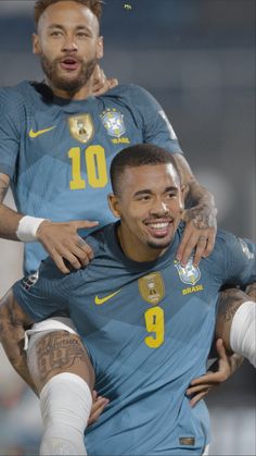 two soccer players are hugging each other in the middle of a photo with their arms around one another