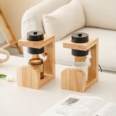 two wooden salt and pepper shakers sitting on a table next to an open book