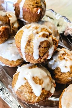 there are muffins with icing on the glass plate