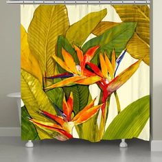 the shower curtain is decorated with tropical flowers and leaves