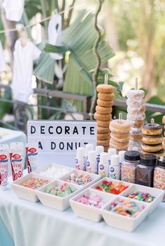 a table topped with lots of different types of donuts and other desserts next to each other