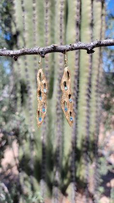 Handcrafted, one of a kind cholla earrings. Tinted gold with blue glass beads Artisan Gold Beaded Earrings, Gold Teardrop Costume Earrings, Gold Freeform Earrings As Gift, Gold Freeform Earrings For Gift, Unique Gold Beaded Earrings For Gift, Artisan Freeform Gold Jewelry, Unique Gold Nickel-free Beaded Earrings, Unique Gold Teardrop Beaded Earrings, Unique Gold Brass Beaded Earrings