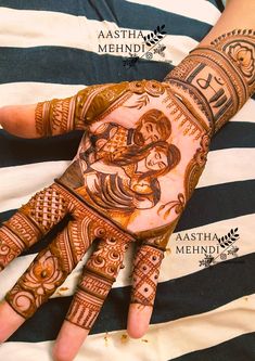 a woman's hand with henna tattoos on it