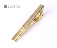 Hold your tie in place with this gold-tone plated tie clip with a simple etched line design. Approximately 2 1/4" in length Gold-tone plated base metal Hinge back closure[custom tab] SHELL #1: 100% METAL INSERT #1: 100% GLASS FIBERS [/custom tab] Gold Tie Clip, Red Necklace Set, Tie Bar Clip, Crystal Dress, Dress Shirt And Tie, Gold Tie, Silver Necklace Set, Tie For Men, Red Necklace