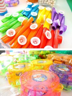 there are many different colored plastic toys on the table and in front of each other