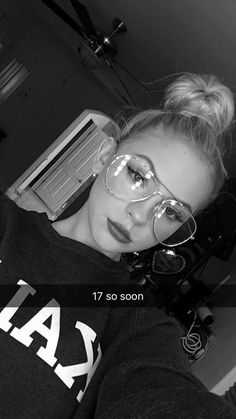 a woman with glasses on taking a selfie in front of a camera and the caption reads, 17 so soon