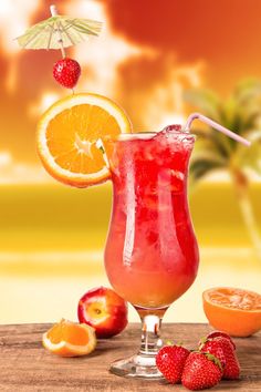 a drink with oranges and strawberries on a table