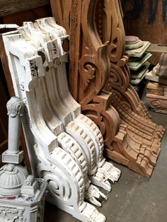 several wooden carvings sitting next to each other on the floor in a room filled with wood planks