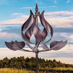 a large metal sculpture in the middle of a field