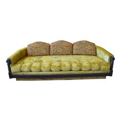 an old fashioned couch with four pillows on it's back and two side ends